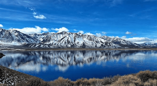 Crowley Lake, California, its still surface reflecting the sky, elevation 6,781 feet.